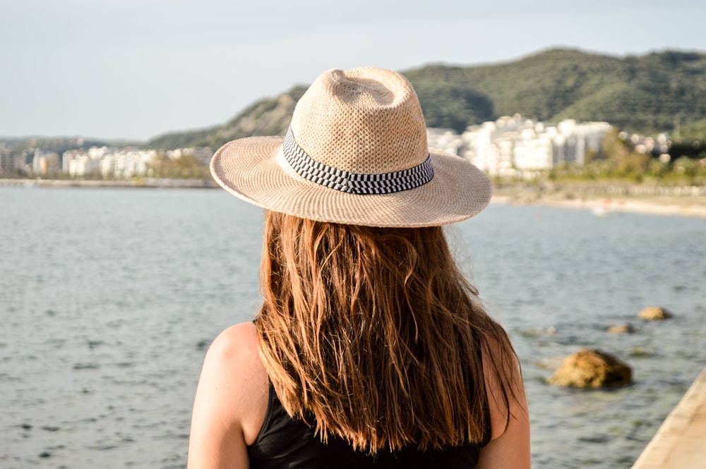 selective focus photography of woman facing body of water