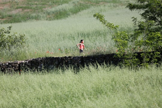 woman running through grass in Bagnaria Italy