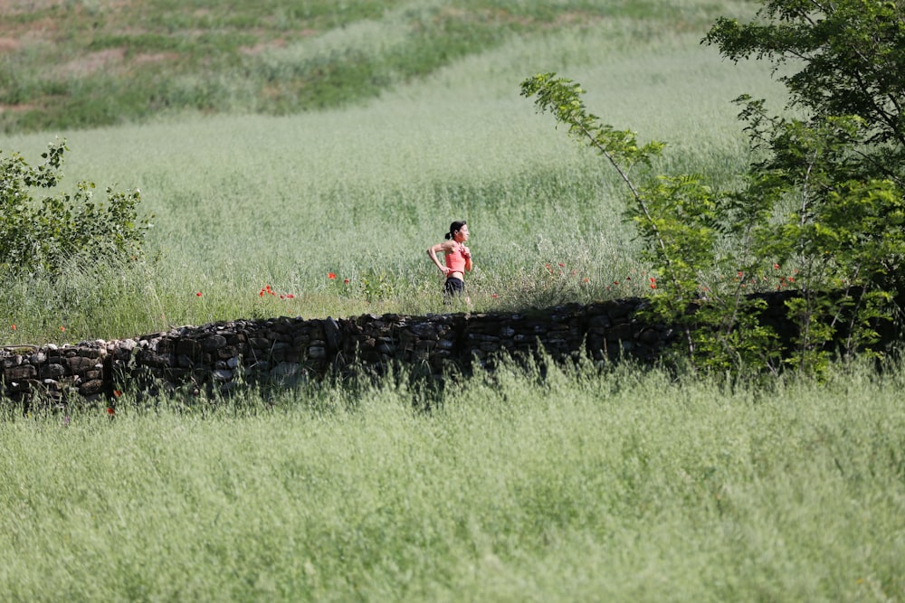 woman running through grass