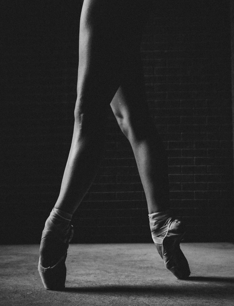 Ballet dancers working at the barre in pointe shoes