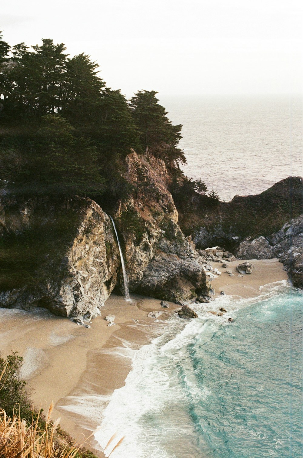 body of water beside rock formations