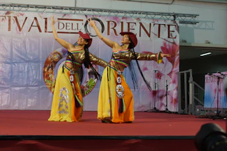 Colorful performers in traditional Central Asian costumes at the Delphic Games festival.
