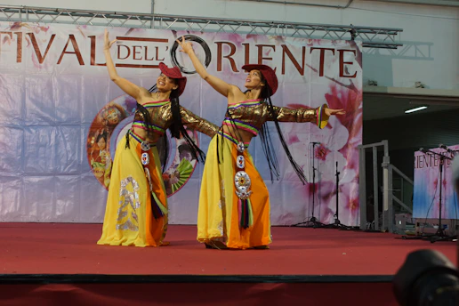 Colorful performers in traditional Central Asian costumes at the Delphic Games festival.