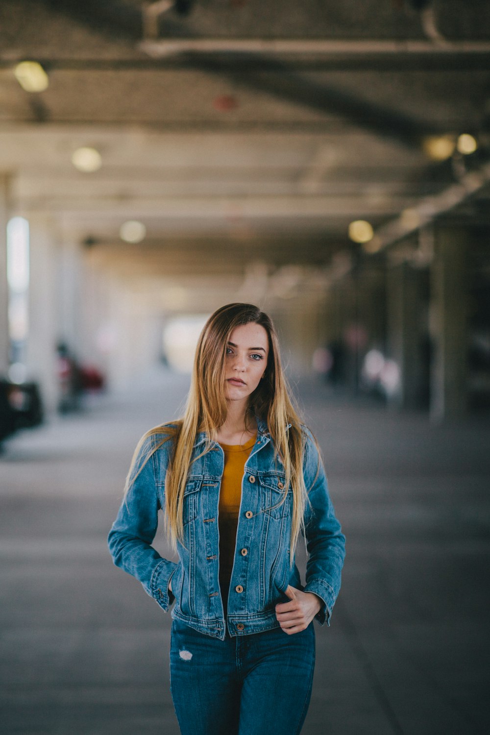 selective focus photography of woman standing on road