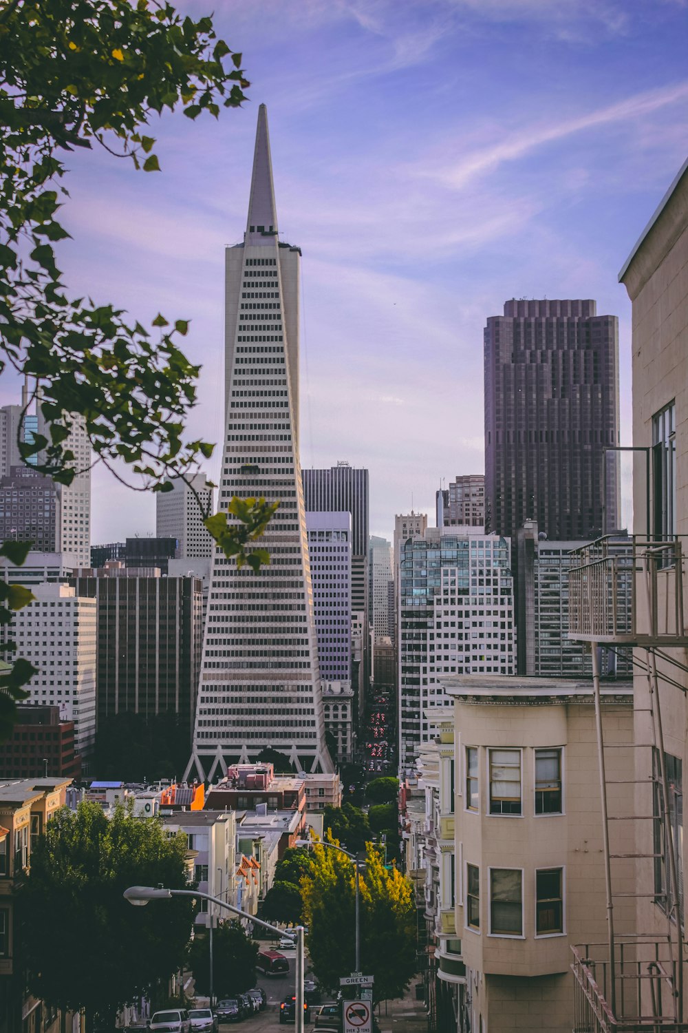 white high-rise tower surrounded by buildings