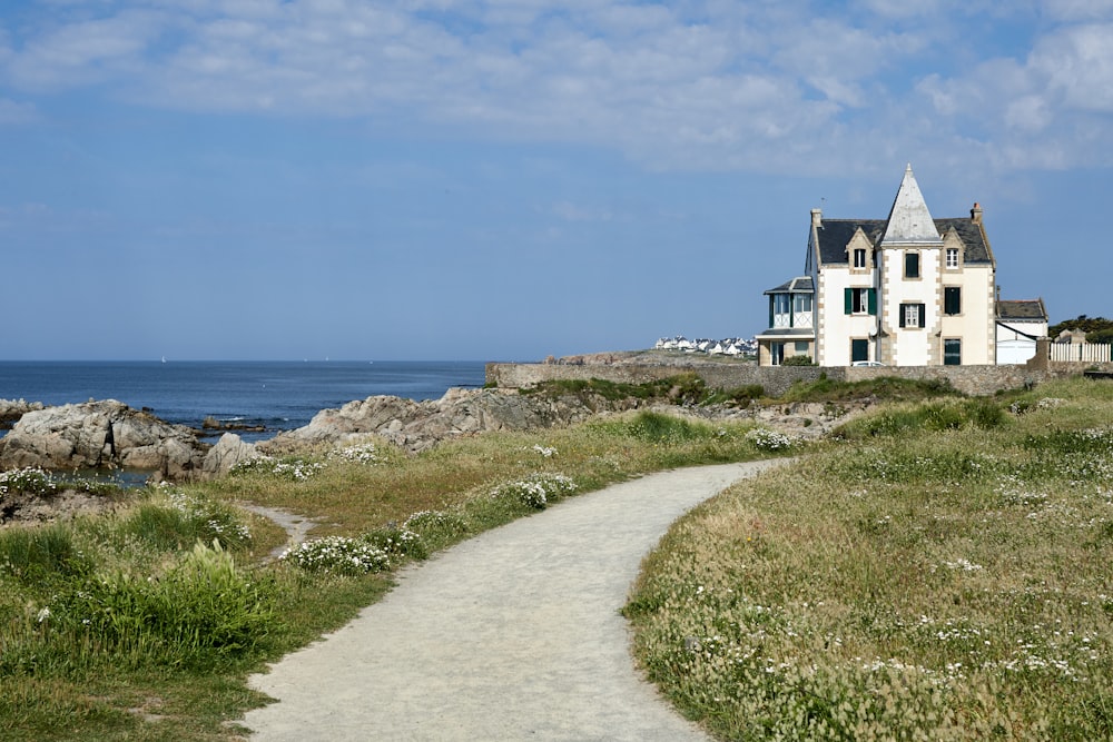 white wooden house near mountain cliff