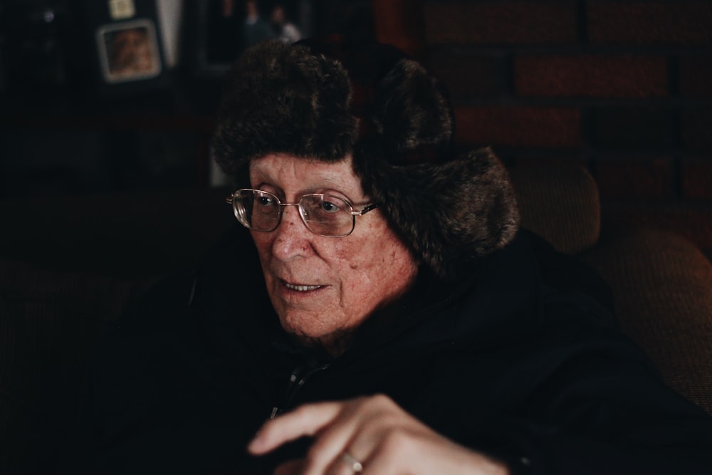 selective focus photo of man in black fur coat