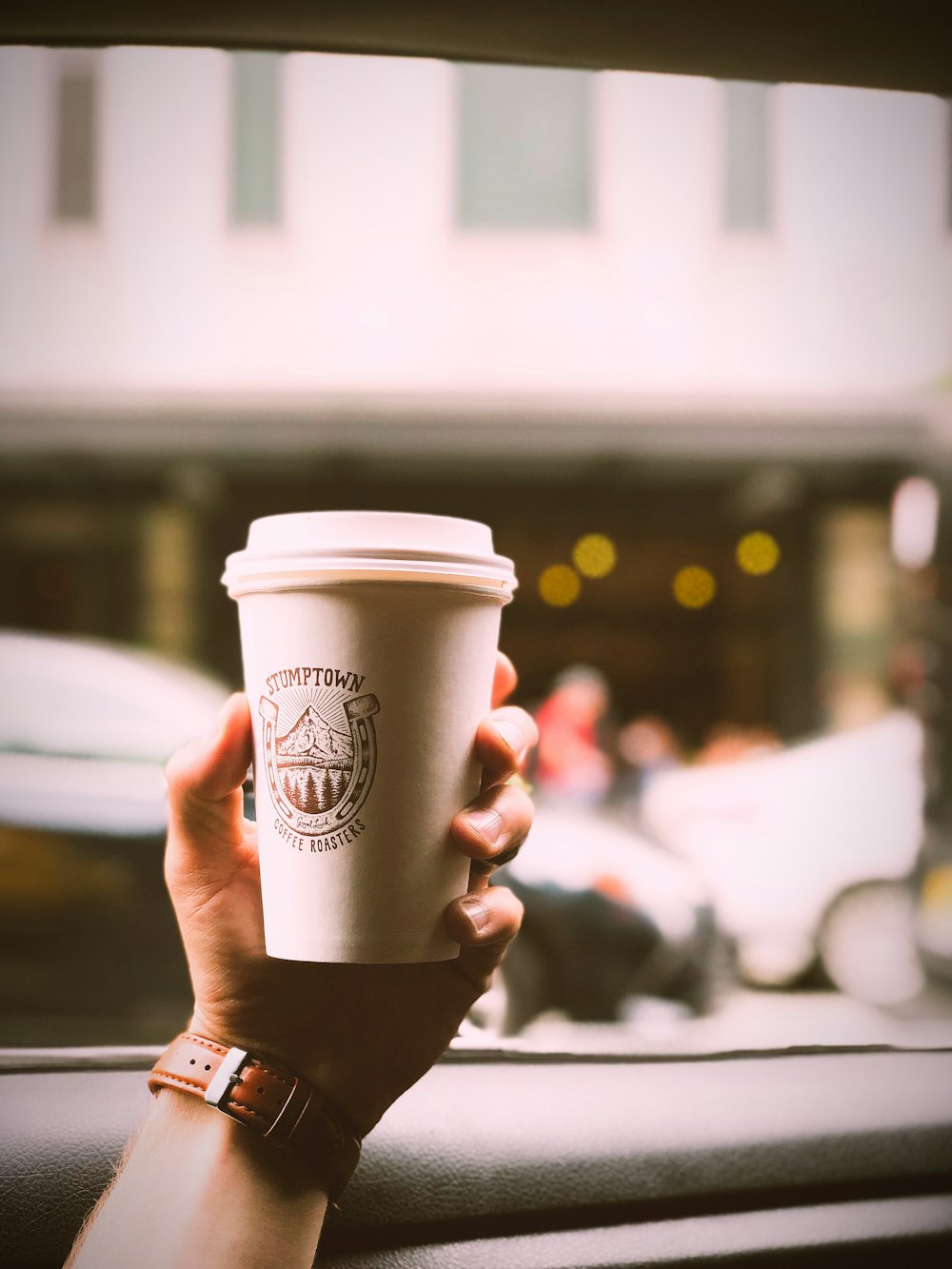 person holding disposable cup