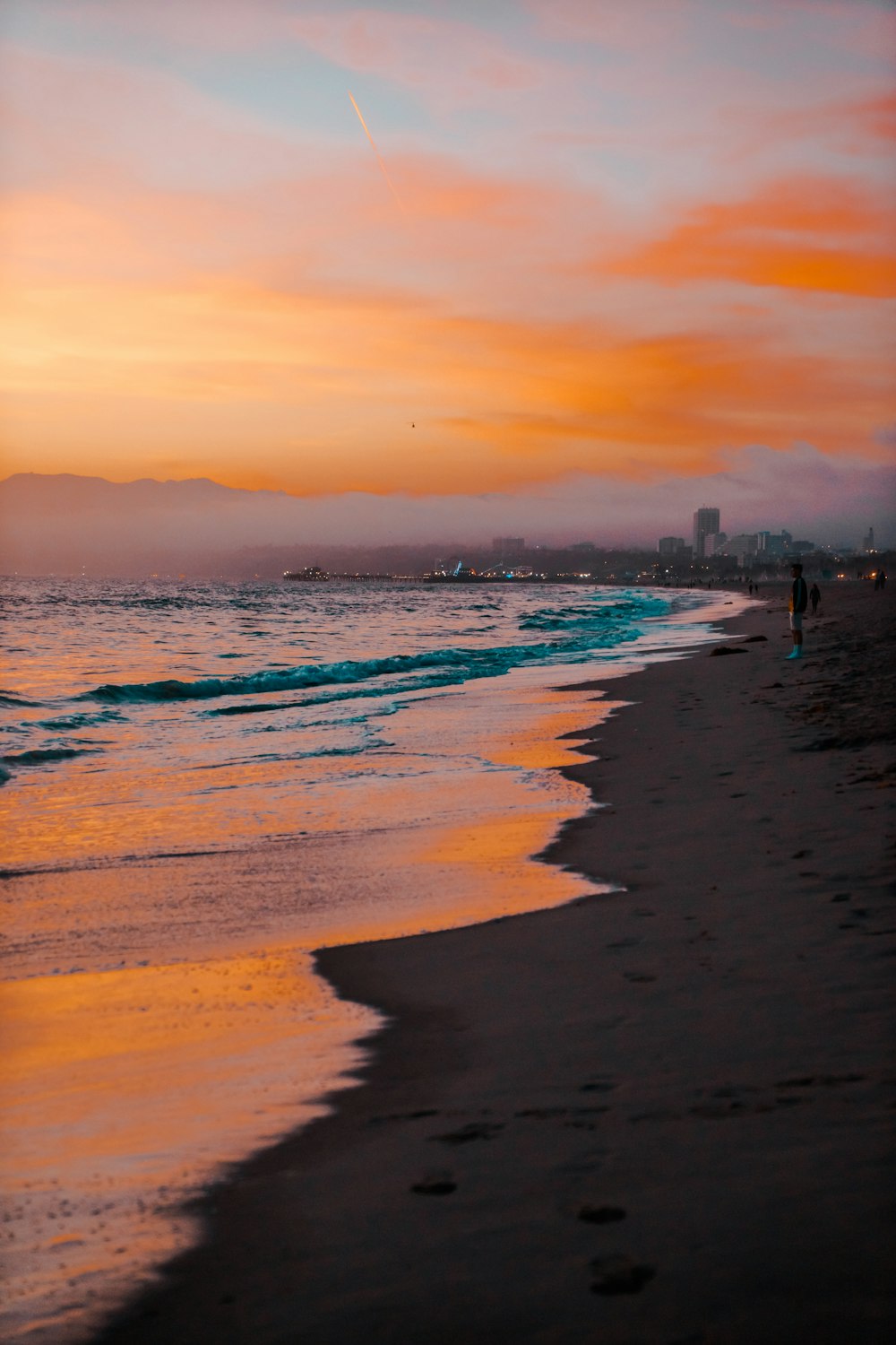 people on beach during sunset