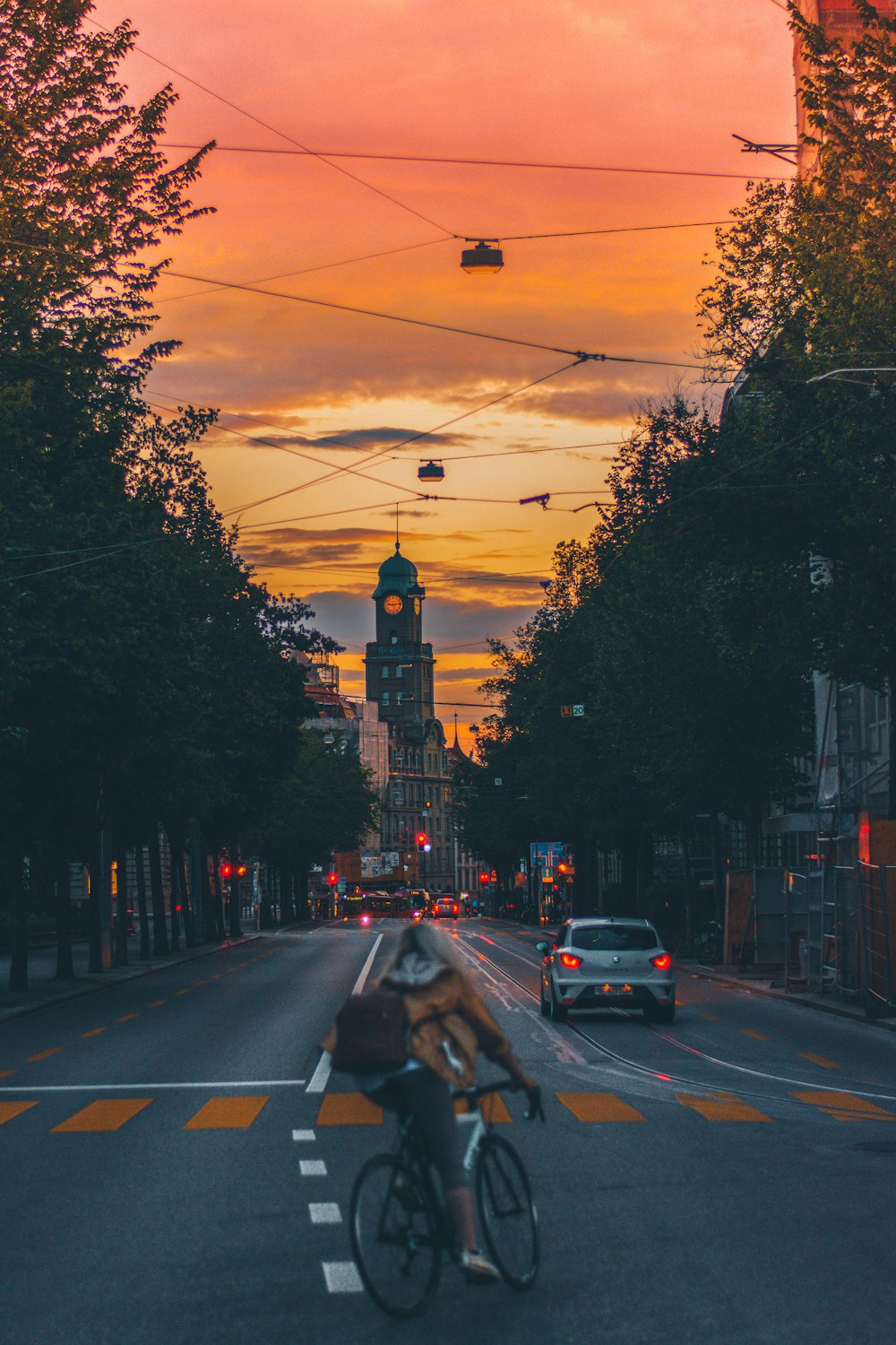 woman riding on her bike between trees