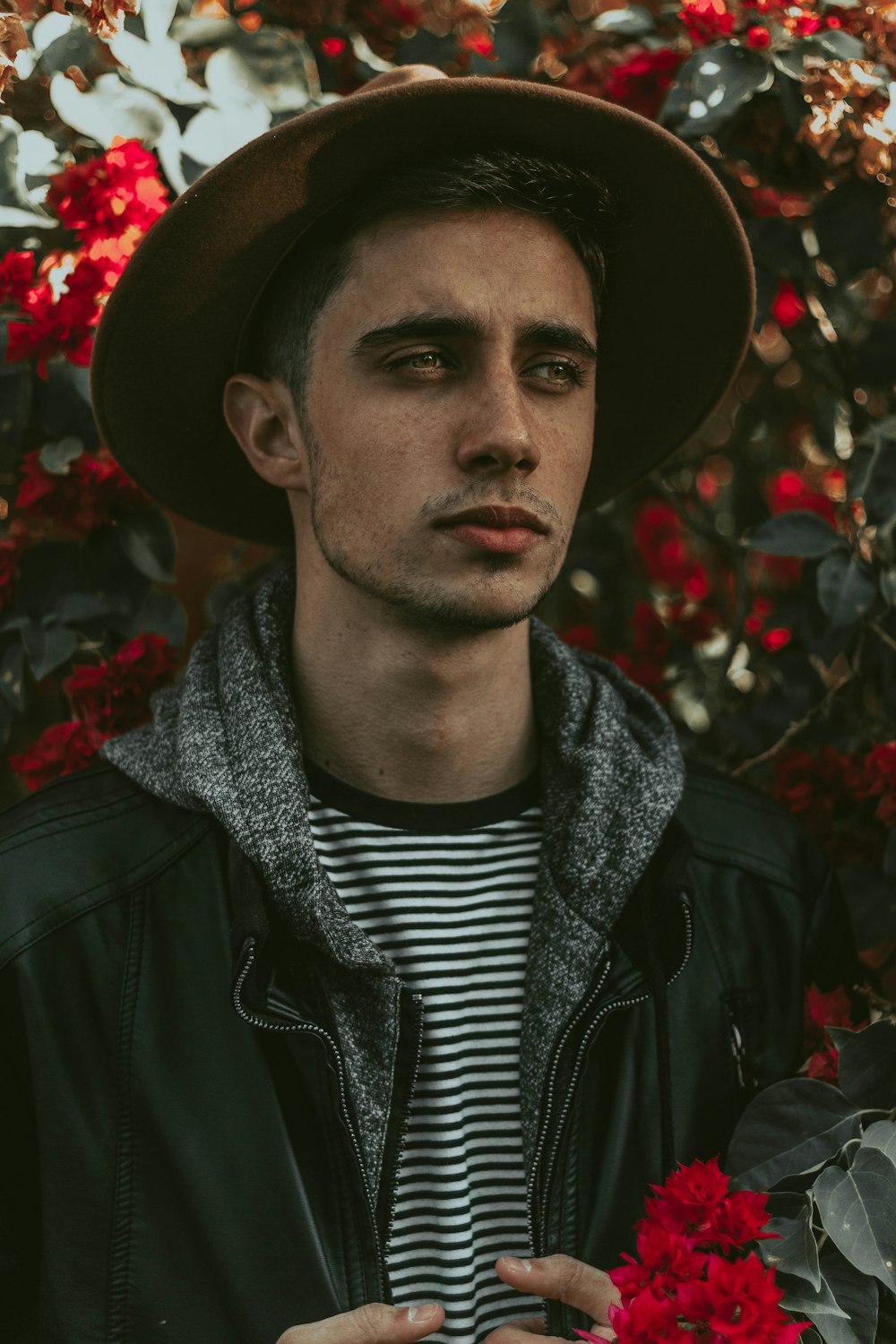 man holding red flowers