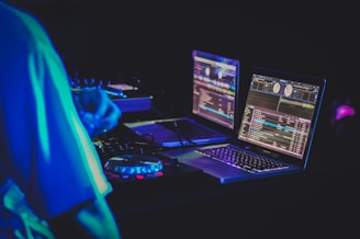two laptop computers and DJ turntables
