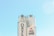 Two large industrial silos with railings and machinery at the top, set against a clear blue sky. The branding on the silo reads 'Davco' with a logo depicting a smiling character giving a thumbs-up.