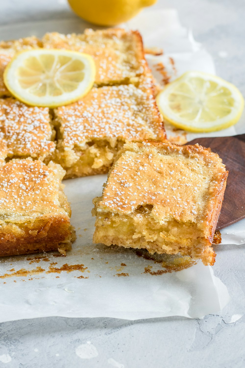 a lemon cake with slices cut out of it