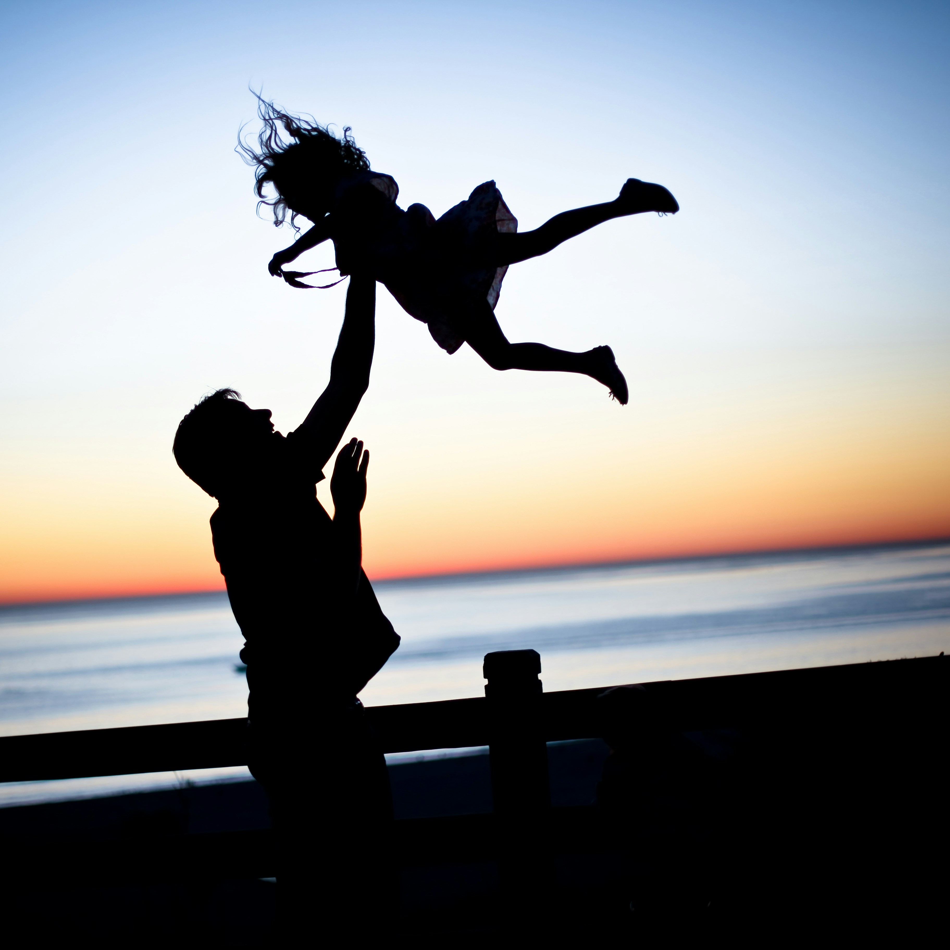 great photo recipe,how to photograph by the ocean in santa monica, my husband tossing my daughter in the air. i love how she trusts him so completely and how he holds back one careful hand just in case she was to fall.; silhouette of man throwing girl in air