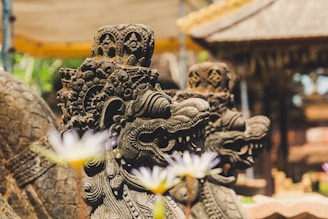 two gray concrete dragon statues outdoor at daytime