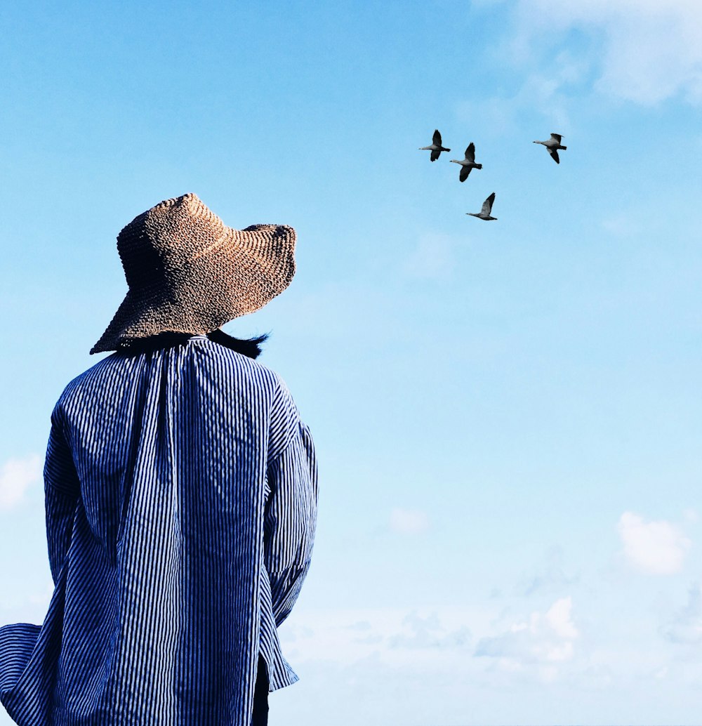 woman looking at flying birds