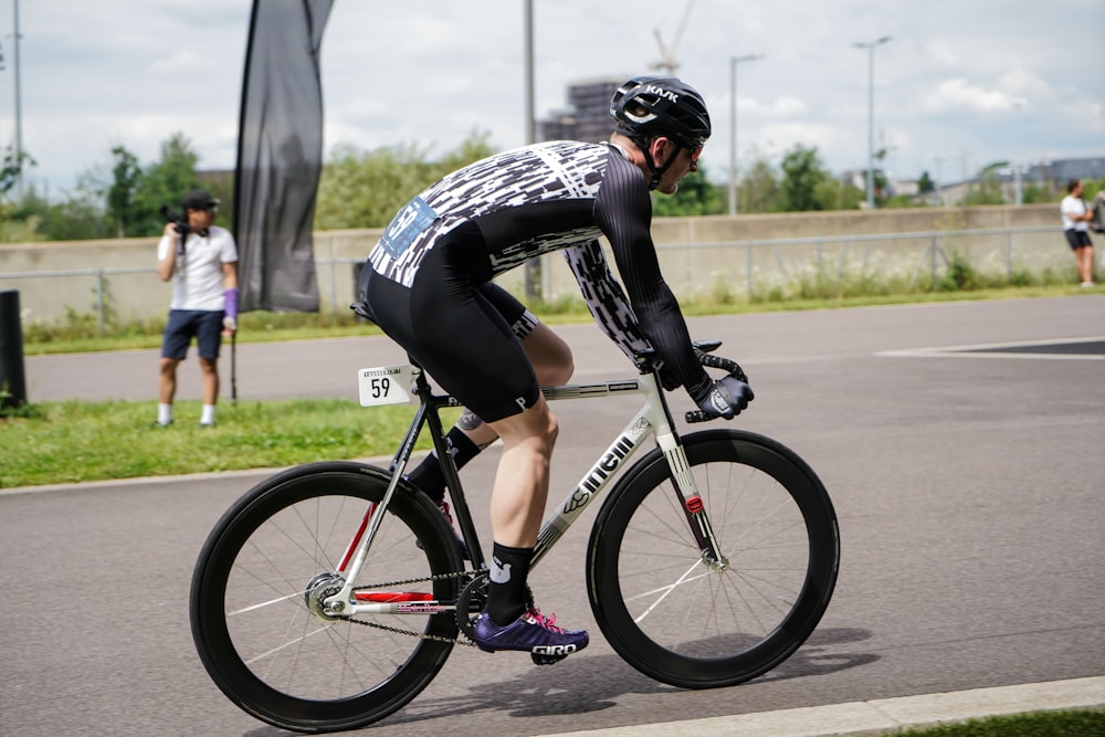 man riding on bike near concrete wall