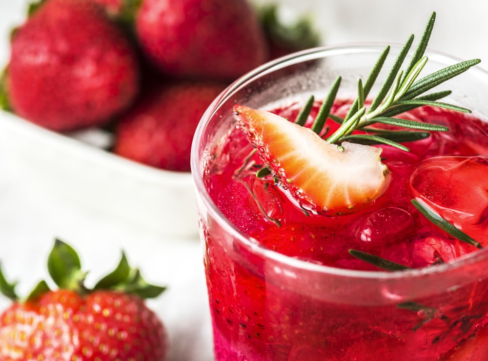 clear drinking glass with strawberry juice on white surface