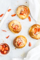 four breads with strawberry toppings
