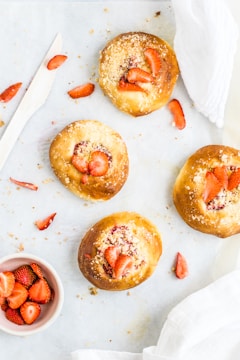 four breads with strawberry toppings