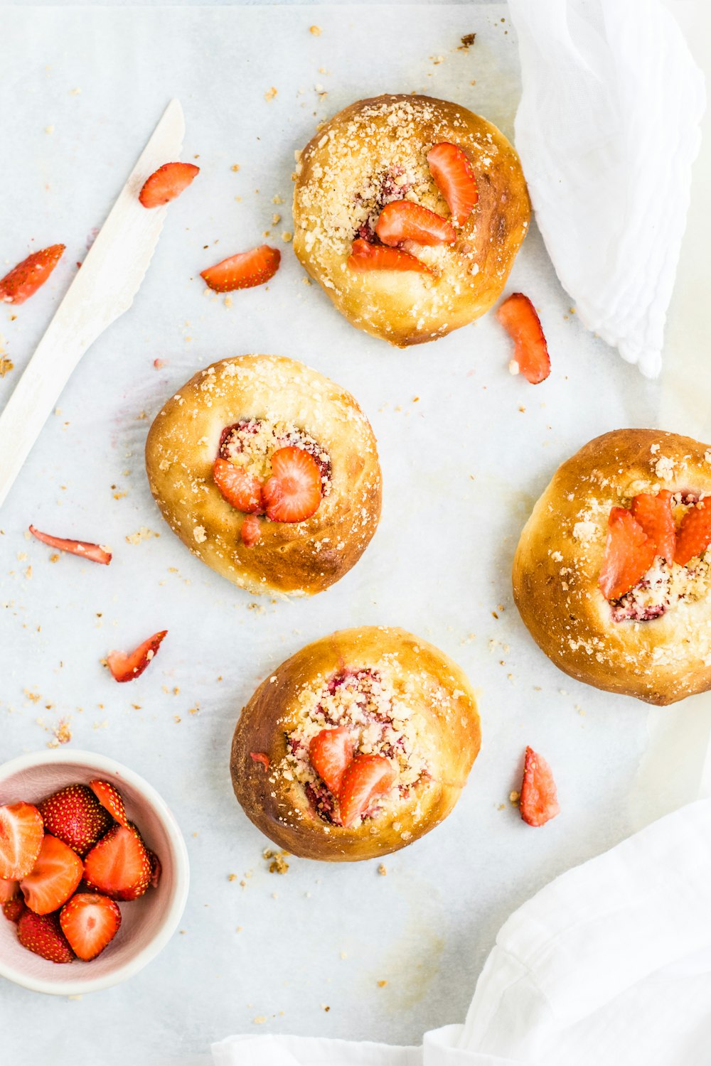 four breads with strawberry toppings