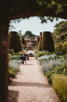 Well-maintained garden with trimmed hedges and vibrant flowers in a residential area