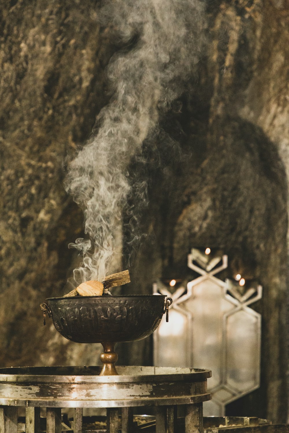 a bowl of food on a table with smoke coming out of it