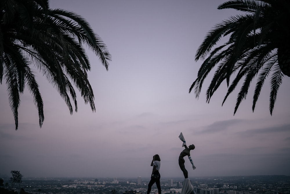 woman standing near statue