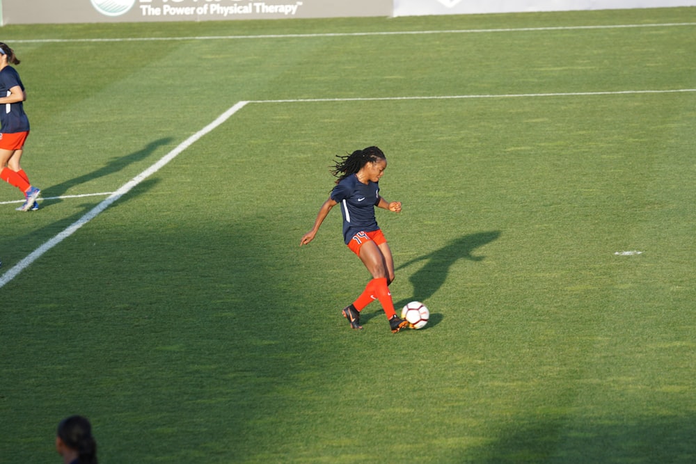 woman playing soccer at daytime