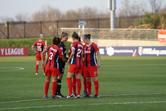 group of women playing on grass field