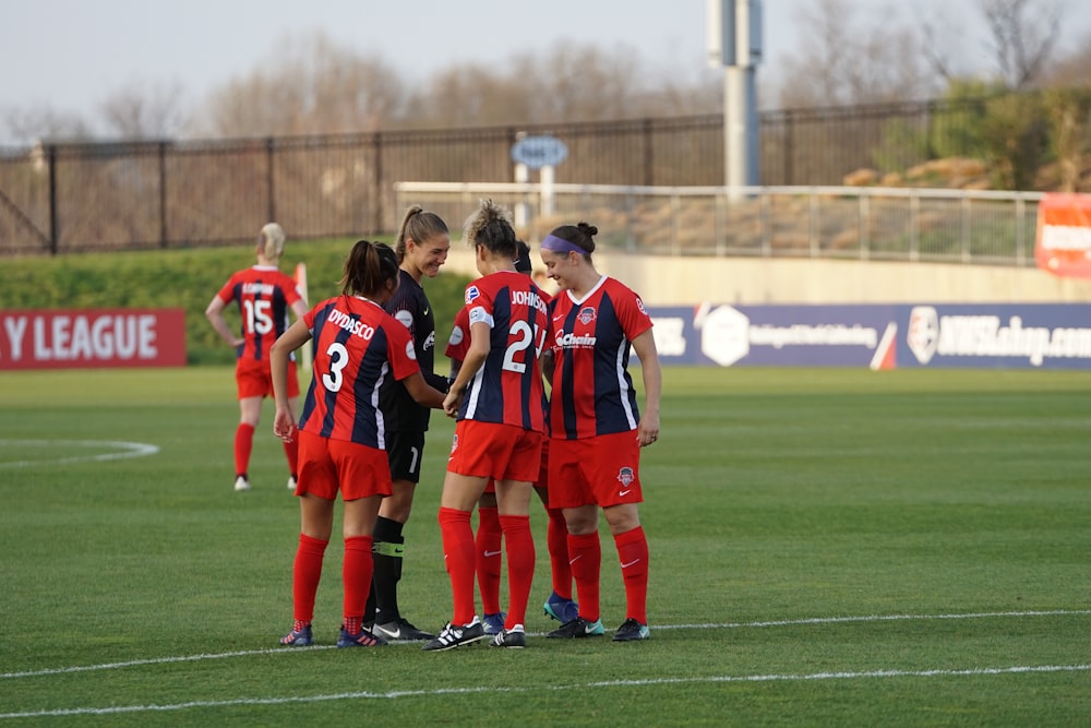 group of women playing on grass field