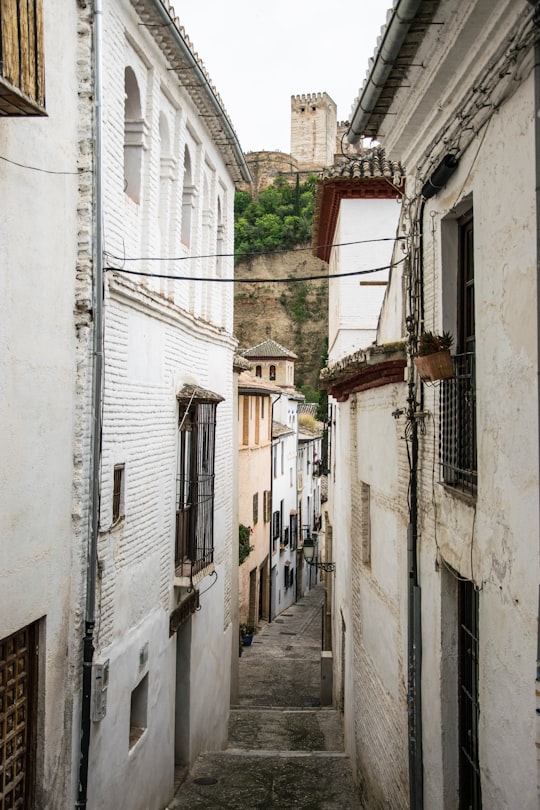 black cables connecting buildings near hill in Granada Spain