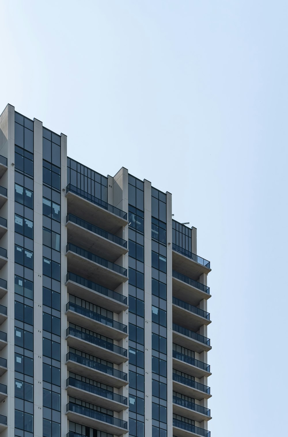 low-angle photography of white high-rise building