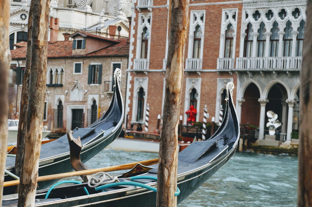 two black row boats on body of water, Gondolas in Venice