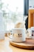 white Boss-printed ceramic mug on brown surface