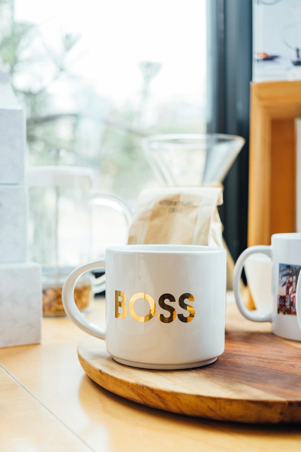 white Boss-printed ceramic mug on brown surface