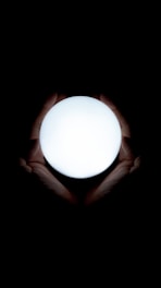 Close-up of hands holding a glowing orb symbolizing energy and balance.