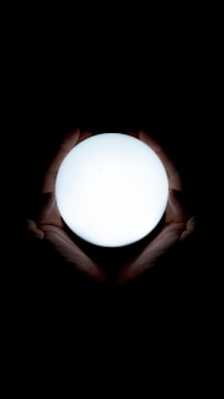Close-up of hands holding a glowing orb symbolizing energy and connection.