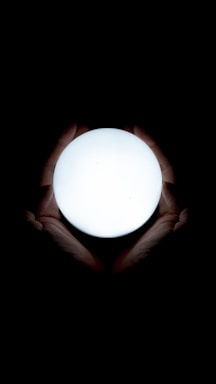 A serene image of hands gently cupping a glowing orb of light symbolizing breath and energy.
