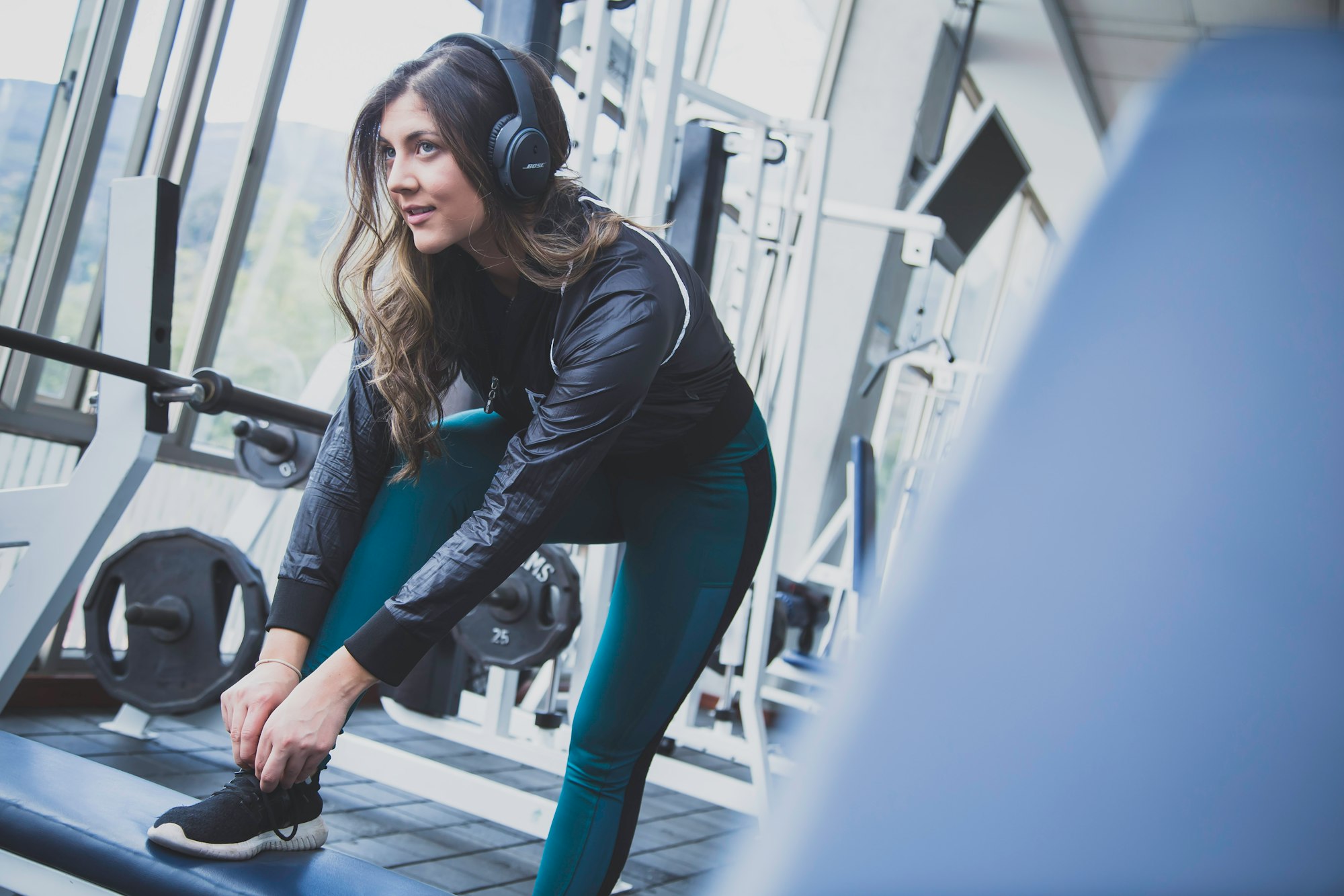 An image of a woman working out while listening to music headphones 