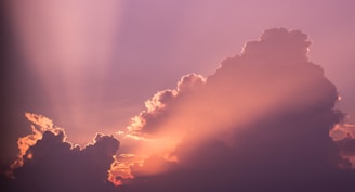 A serene lavender sky with soft glowing angelic light beams.
