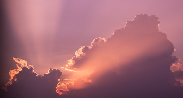 A serene lavender sky with soft glowing angelic light beams.