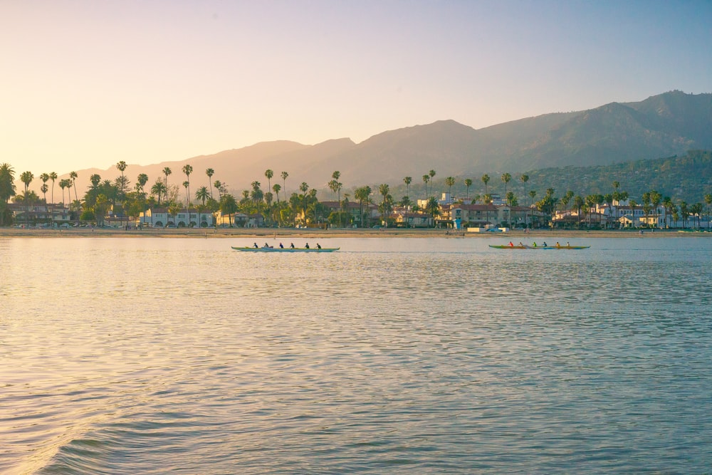 people riding boat on body of water during daytime