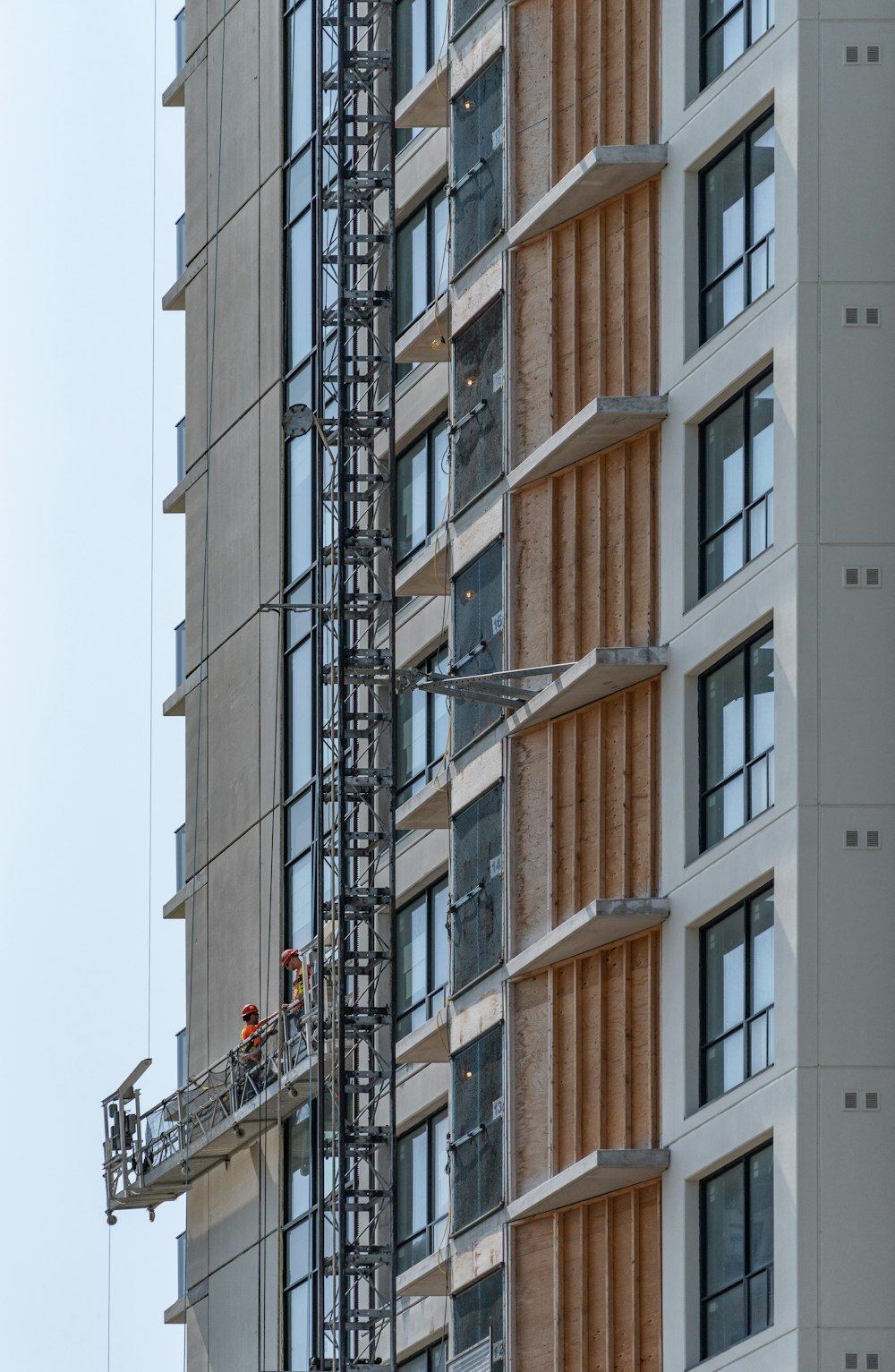 two persons on cleaning buildings window