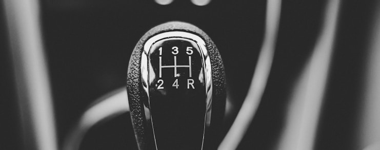 focus photography of car shift gear