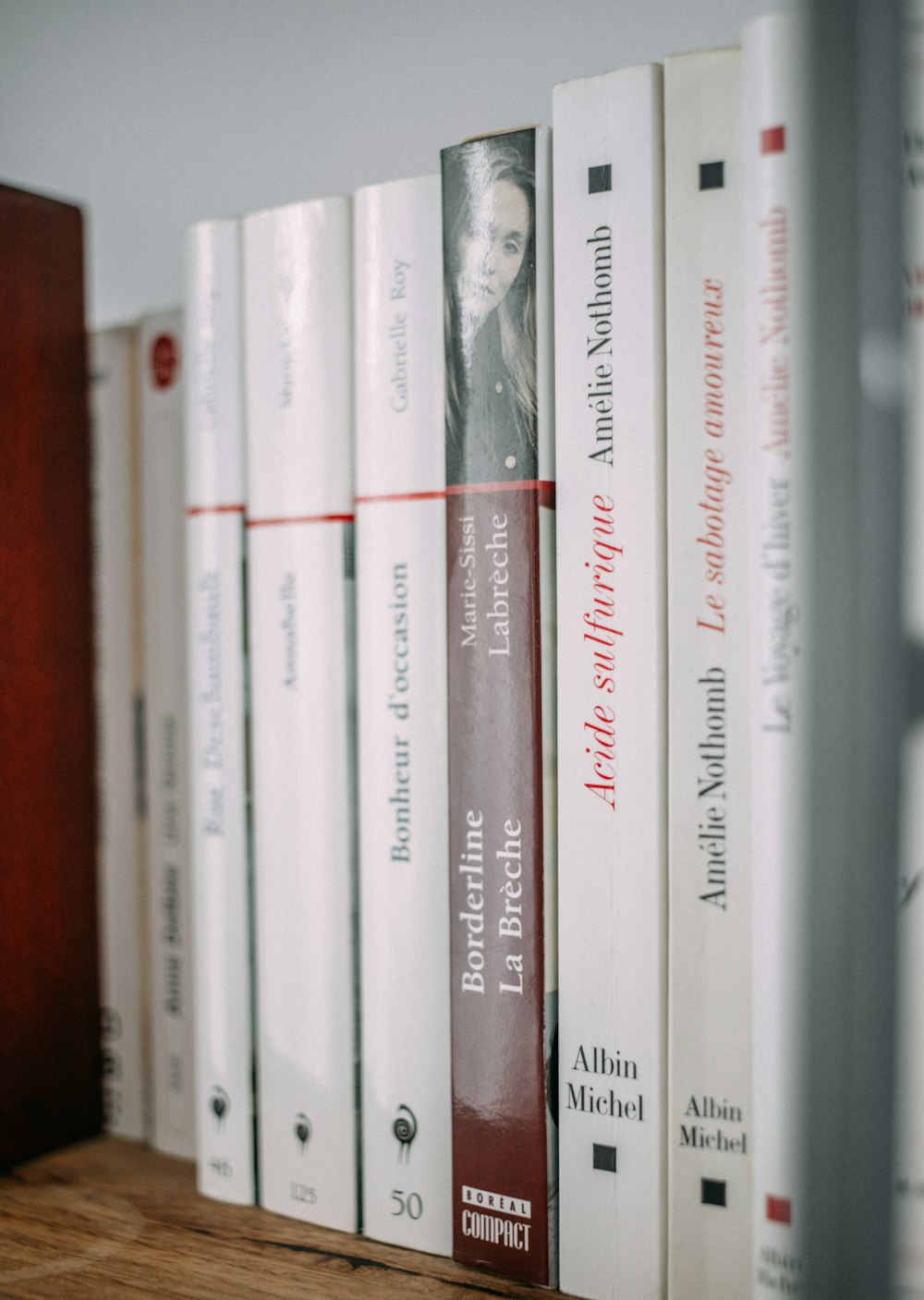 pile of books on brown wooden surface