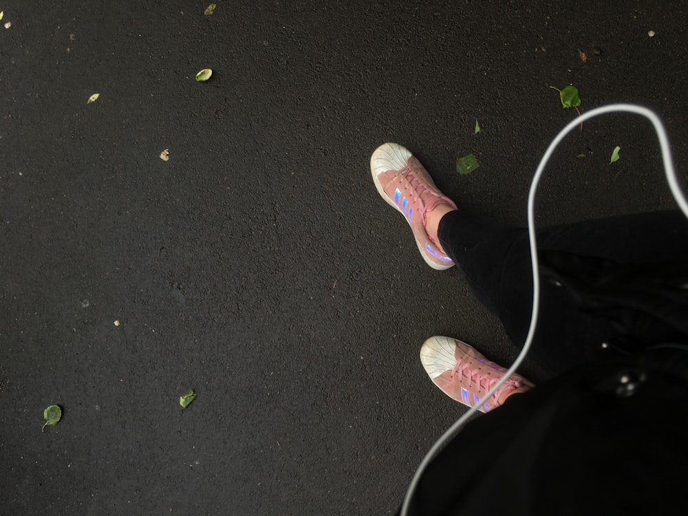 person wearing pink sneakers