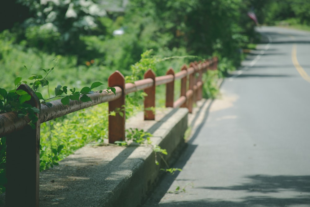 red metal railings on roadside at daytime