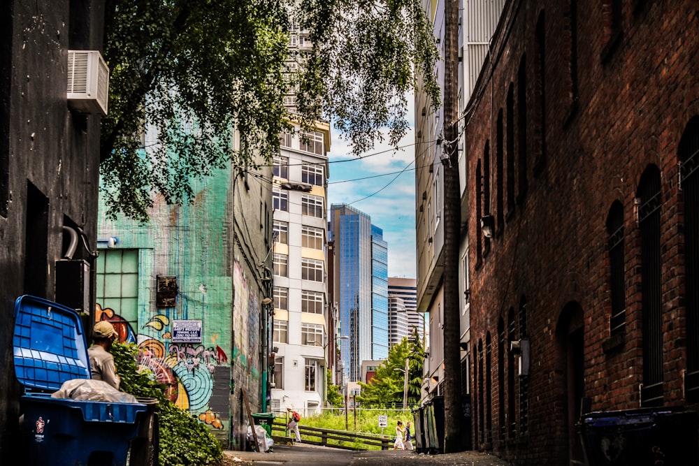 concrete buildings near green tree painting